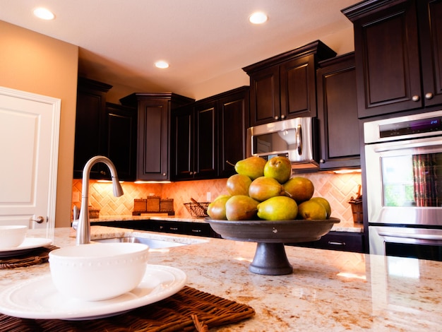 Modern kitchen with dark wood cabinets and hardwood floors.