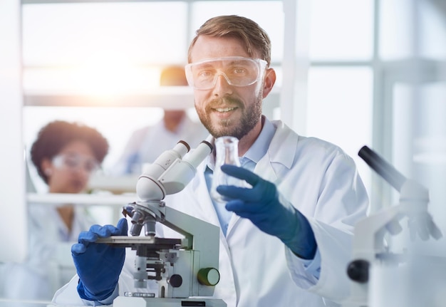 in a modern laboratory research scientist conducts experiments