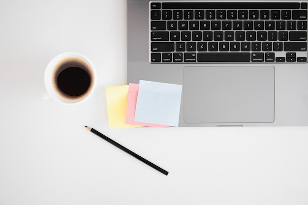 Modern laptop cup of coffee on table and sticky notes