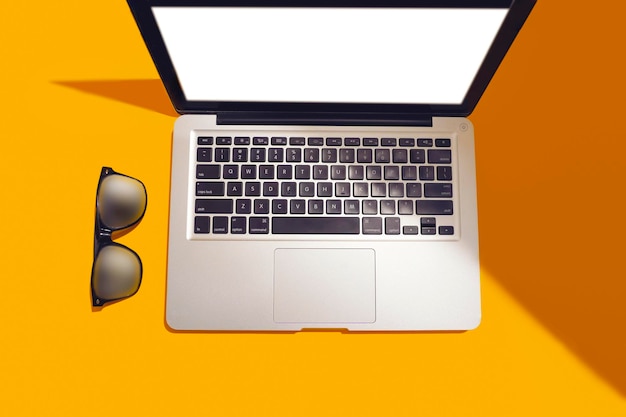 Modern laptop isolated on yellow background