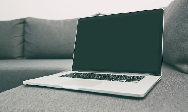 modern laptop on the new gray sofa