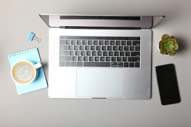 Modern laptop and stationery on the table top view