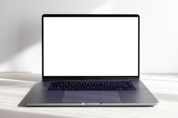 Photo modern laptop with blank white screen on minimalist desk