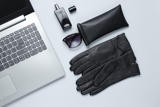 Modern laptop, women's accessories on gray table. Top view