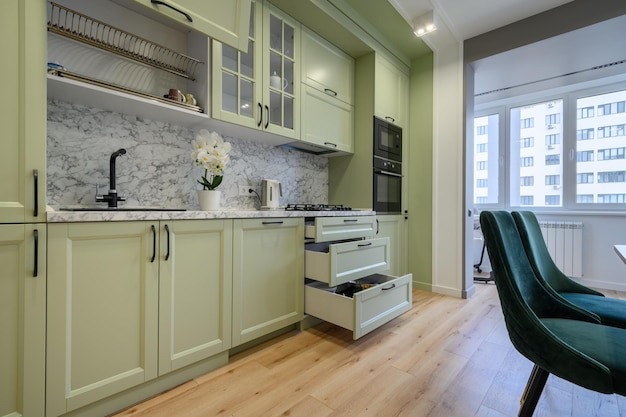 Modern light green luxurious kitchen with dining table