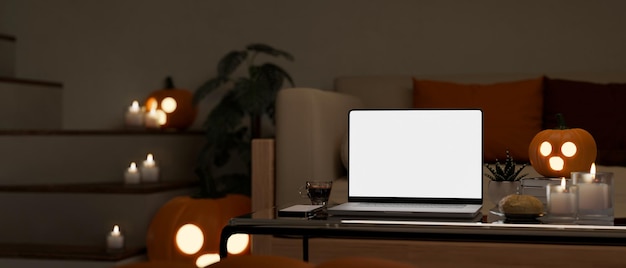 Modern living room in halloween night with laptop mockup and
halloween decor on coffee table