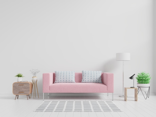 Modern living room interior with pink sofa and green plants, lamp, table on white wall.