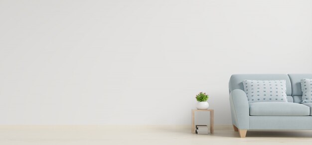 Interno moderno del salone con il sofà e le piante verdi, tavola sul fondo bianco della parete.