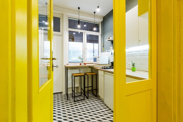 Modern loft style kitchen with yellow interior doors