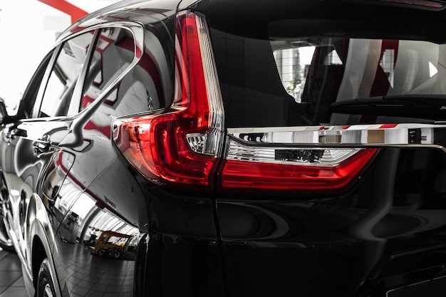 modern luxury car closeup concept of expensive sports auto headlight lamp of new carscopy space luxury red super car details view elegant and beautiful super car back brake light view