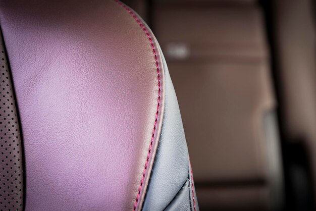 Modern luxury car red perforated leather interior Part of stitched leather car seat details