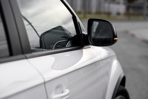 Modern luxury car wing mirror close-up. Expensive, sports auto.