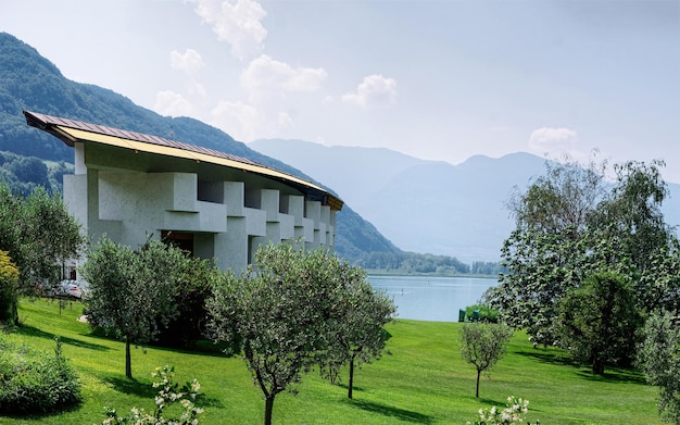 Modern luxury hotel or villa building architecture and landscape in day. Caldaro Lake at South Tirol in Italy. Lifestyle view. Italian Resort with background on summer. Urban design. Mixed media.