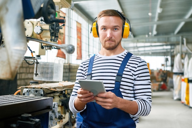 Modern Machine Operator Working at Plant