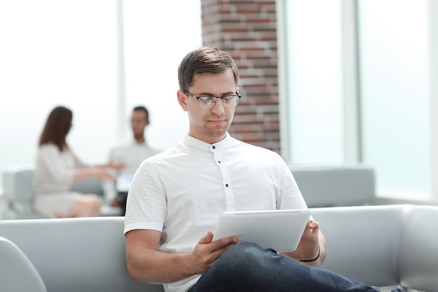 Modern man uses a digital tablet for reading