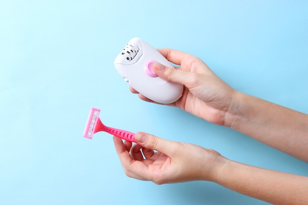 Modern mechanical epilator on a colored background closeup