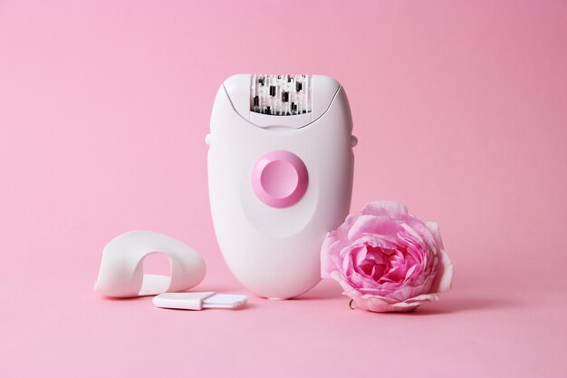 Modern mechanical epilator on a colored background closeup