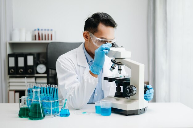 Modern medical research laboratory male scientist working with micro pipettes analyzing biochemical samples advanced science chemical laboratory for medicine