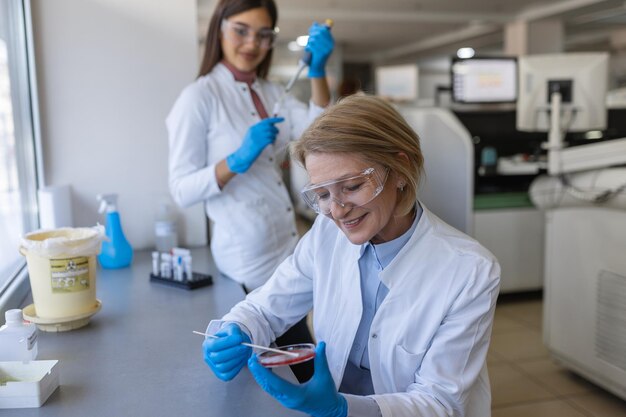 Modern Medical Research Laboratory Two Scientists Working Together Analysing Chemicals in Laboratory Discussing Problem Advanced Scientific Lab for Medicine Biotechnology Molecular Biology