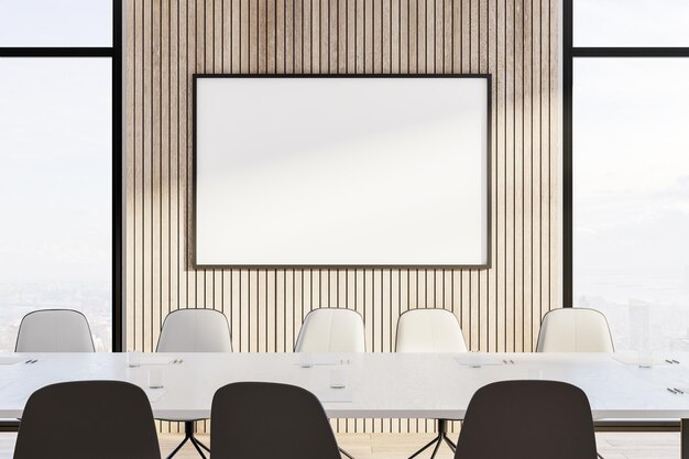 Modern meeting room with empty frame on wooden wall