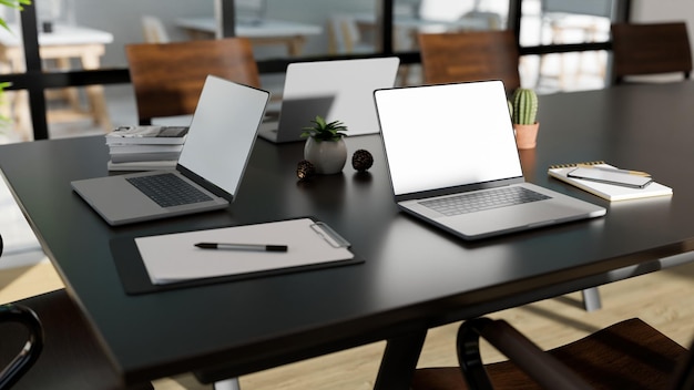 Modern meeting table in the conference or meeting room with portable notebook laptop and decor