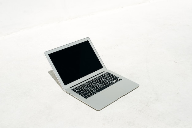 Modern metal laptop on a white surface.