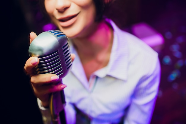 Modern microphone for singing against beautiful blurry colored bokeh.