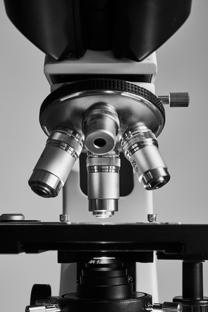 Modern microscope with metal lens at laboratory