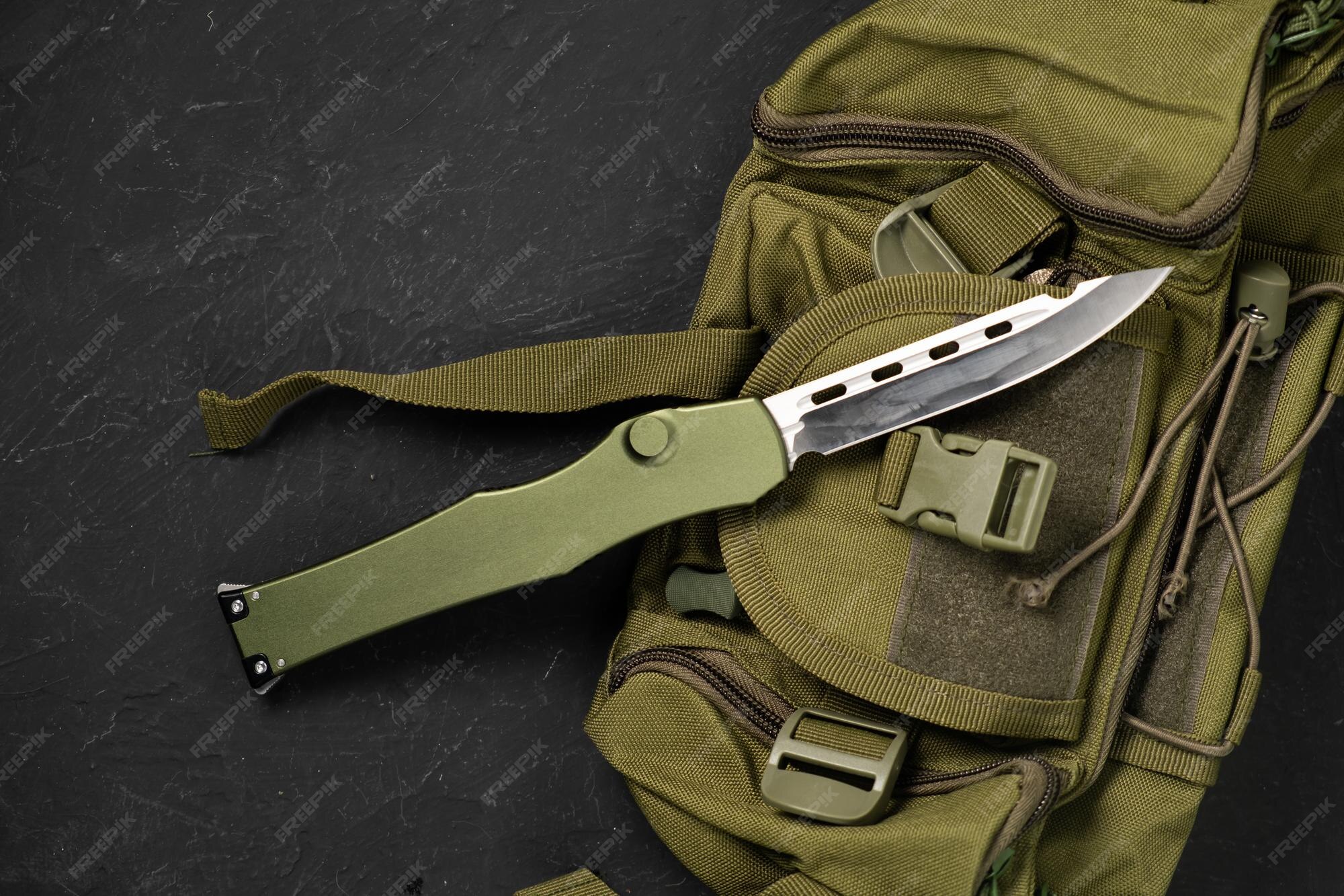 Premium Photo | A Modern Military Knife And A Plastic Sheath For It Edged  Weapons Lie On A Military Olivecolored Backpack