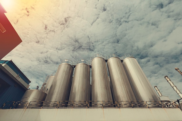 Modern milk cellar with stainless steel tanks with red light