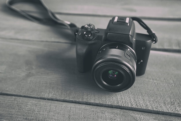 The modern mirrorless camera on the wooden desk