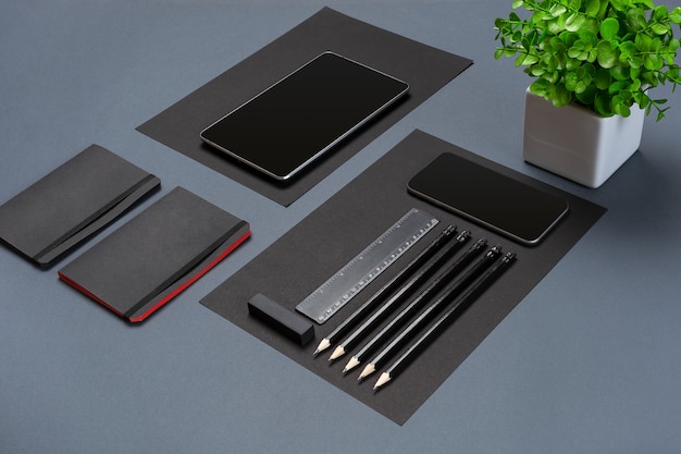 Modern mock up flat lay of notebook and stationery on gray background