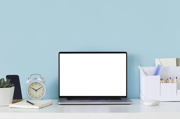 Modern mockup with office desk on white table background. Modern style workplace in blue wall background.