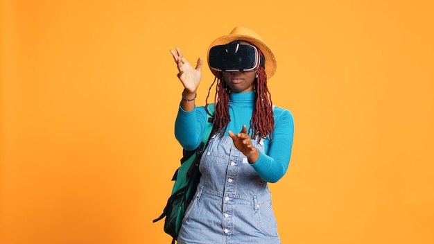 Modern model using vr glasses on holiday, having fun with artificial intelligence and virtual reality headset. female tourist using 3d interactive vision on goggles, urban adventure