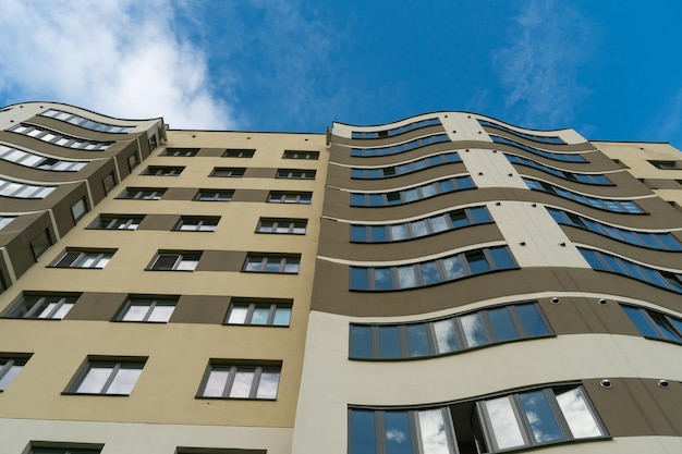 Modern multistorey building in the city center against the\
background of clouds beautiful tall building in a russian city