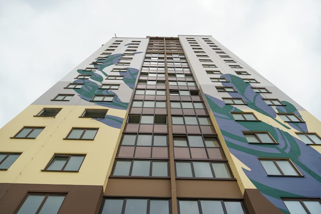 Modern multistorey house in a new residential complex against the blue sky The concept of mortgage housing lending and a happy family life Beautiful multicolored house in the city