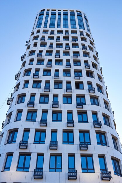 A modern multistorey residential building with windows and balconies The facade of the house Construction