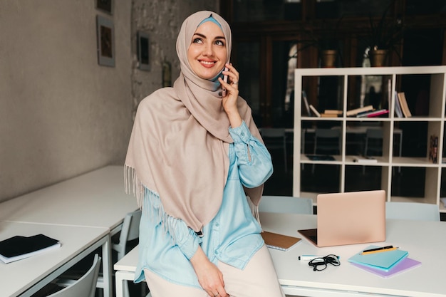 Modern muslim woman in hijab in office room