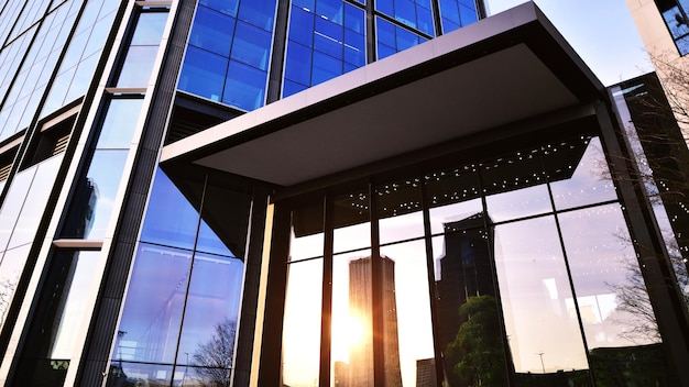 Modern office building with glass facade on a clear sky background Transparent glass wall