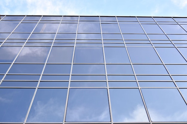 Modern office building with glass facade on a clear sky background Transparent glass