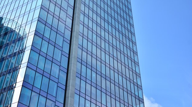 Modern office building with glass facade on a clear sky background Transparent glass