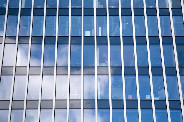 Modern office building with glass facade on a clear sky background Transparent glass