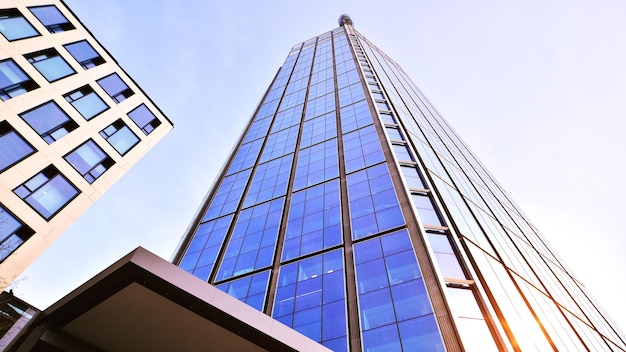 Modern office building with glass facade on a clear sky