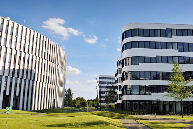 Modern office building with white metallic panel facade and windows modern architectural details