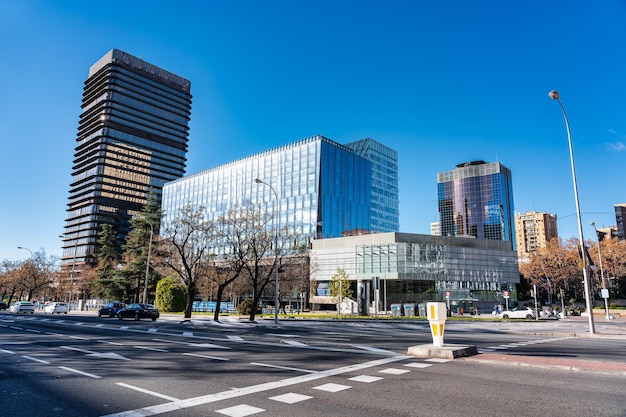 Modern office buildings that reflect other skyscrapers in Madrid in their windows