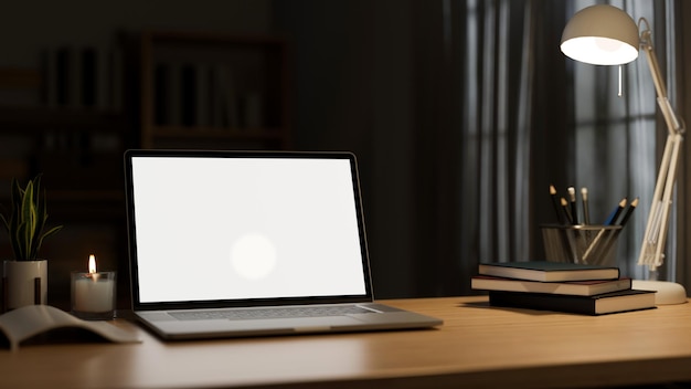 Modern office desk workspace in the darkness room with laptop
mockup and accessories