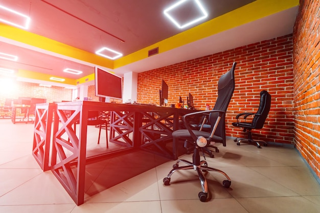 Modern office room Design of a working place Brick wall background Wooden style table