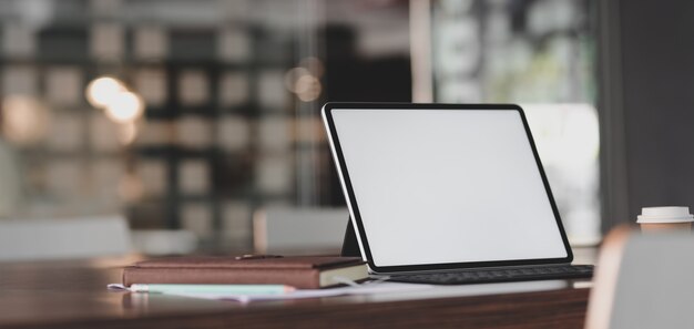 modern office room with blank screen tablet and office supplies