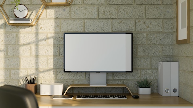 Modern office studio workspace with computer and accessories on table against minimal brick wall