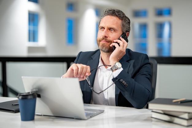 modern office successful caucasian business man in business suit using laptop working remotely